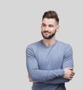 Portrait of handsome smiling young man with folded arms isolated on gray background. Joyful cheerful men with crossed hands Royalty Free Stock Photo