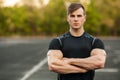 Portrait of handsome sports man in sportswear outdoor. Athletic male outside