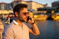 Portrait of handsome stylish man chatting on phone in big city. Sexy man in casual clothes talking on phone on the Royalty Free Stock Photo