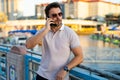 Portrait of handsome stylish man chatting on phone in big city. Sexy man in casual clothes talking on phone on the Royalty Free Stock Photo