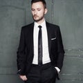 Portrait of handsome stylish man in elegant black suit