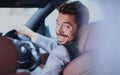 Portrait of an handsome smiling business man driving his car Royalty Free Stock Photo