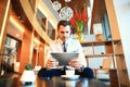 Portrait of handsome successful man drink coffee and look to the digital tablet screen sitting in coffee shop, business Royalty Free Stock Photo