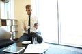 Portrait of handsome successful man drink coffee sitting in coffee shop, business man having breakfast at hotel lobby. Royalty Free Stock Photo