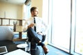 Portrait of handsome successful man drink coffee sitting in coffee shop, business man having breakfast at hotel lobby. Royalty Free Stock Photo