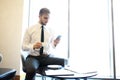 Portrait of handsome successful man drink coffee sitting in coffee shop, business man having breakfast at hotel lobby. Royalty Free Stock Photo