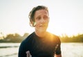 Portrait of a handsome teen boy surfing rashguard on the sand Indian ocean beach with sunset on background. Happy teen time and Royalty Free Stock Photo