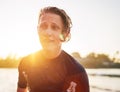 Portrait of a handsome teen boy surfing rashguard on the sand Indian ocean beach with sunset on background. Happy teen time and Royalty Free Stock Photo