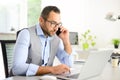 Portrait of handsome trendy casual mid age business man in office desk with laptop computer Royalty Free Stock Photo