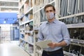 Portrait of handsome warehouse wears medical mask during epidemy. Worker in a cash and carry wholesale store