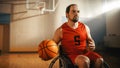 Portrait of Handsome Wheelchair Basketball Player Wearing Red Shirt Dribbling Ball, Ready to Shoot Royalty Free Stock Photo