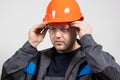 Portrait of a handsome worker builder in overalls, helmet and glasses on a white background. Royalty Free Stock Photo