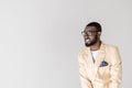 portrait of handsome young african american man in eyeglasses smiling and looking away Royalty Free Stock Photo