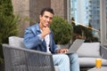 Portrait of handsome young -American man with laptop in outdoor cafe Royalty Free Stock Photo