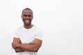 Handsome young african american man smiling with arms crossed against isolated white background Royalty Free Stock Photo