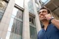 Portrait of handsome young African-American man talking on mobile phone, low angle view. Space for text Royalty Free Stock Photo