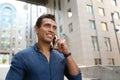 Portrait of handsome young African-American man talking on mobile phone outdoors Royalty Free Stock Photo