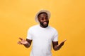 Portrait of handsome young african guy smiling in white t-shirt on yellow background Royalty Free Stock Photo