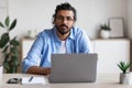 Portrait Of Handsome Young Arab Freelancer Guy Sitting At Desk With Laptop Royalty Free Stock Photo