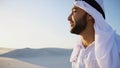 Portrait of handsome young Arabian Sheikh who drinks from cup of Royalty Free Stock Photo