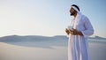 Portrait of handsome young Arabian Sheikh who drinks from cup of Royalty Free Stock Photo