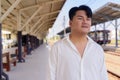 Portrait of Handsome Young Asian Man Outdoors Waiting For Train Royalty Free Stock Photo