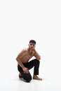 Portrait of handsome young asian man posing shirtless in pants against white studio background. Muscular fit body shape Royalty Free Stock Photo