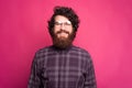 Portrait of handsome young bearded hipster man wearing round glasses and looking at the camera Royalty Free Stock Photo