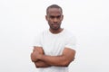 Handsome young black man posing with arms crossed against white background Royalty Free Stock Photo