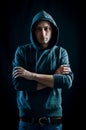 Portrait of a handsome young blue-eyed hooded man with his arms crossed Royalty Free Stock Photo