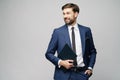 Portrait of a handsome young business man holding document folder Royalty Free Stock Photo