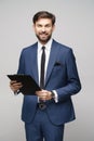 Portrait of a handsome young business man holding folder Royalty Free Stock Photo