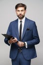 Portrait of a handsome young business man holding folder Royalty Free Stock Photo