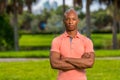 Portrait handsome young businessman posing outdoors in a pink polo shirt