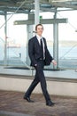 Portrait of a handsome young businessman walking in the city Royalty Free Stock Photo