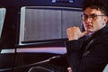 Portrait of a handsome young businessman sitting in the back seat of the luxury car. Royalty Free Stock Photo