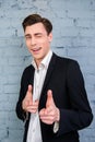 Portrait of handsome young businessman winking and pointing on camera Royalty Free Stock Photo