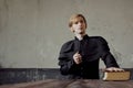 Portrait of handsome young catholic priest praying to God. Dark style, concept doubt Royalty Free Stock Photo