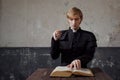 Portrait of handsome young catholic priest praying to God. Royalty Free Stock Photo