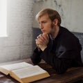 Portrait of handsome young catholic priest praying to God. Royalty Free Stock Photo