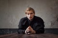 Portrait of handsome young catholic priest praying to God. Dark style, concept doubt Royalty Free Stock Photo