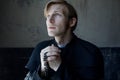 Portrait of handsome young catholic priest praying to God. Royalty Free Stock Photo