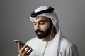 Portrait Of A Young Confident Arab Businessman Wearing UAE Emirati Tradational Dressn Holding A Mobile   ARAB EMIRATI MODEL Royalty Free Stock Photo