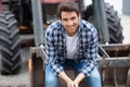 Portrait handsome young farmer smiling at camera