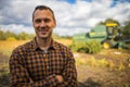 Portrait of young Caucasian handsome happy man farmer standing in field and smiling to camera.