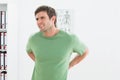 Portrait of a handsome young man with back pain Royalty Free Stock Photo