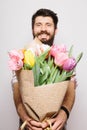 Portrait Handsome young man with beard and nice bouquet of flowers Royalty Free Stock Photo