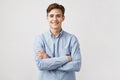 Portrait of handsome young man in casual blue shirt. Boy smiles for the camera expressing happiness and joy. His cute Royalty Free Stock Photo