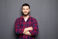 Portrait of handsome young man in casual shirt keeping arms crossed and smiling Royalty Free Stock Photo