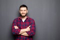 Portrait of handsome young man in casual shirt keeping arms crossed and smiling Royalty Free Stock Photo